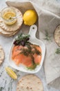 Gravlax a raw, marinated graved salmon with dill on plate with crispbread, Scandinavian mustard sauce, lemon and linen towel on Royalty Free Stock Photo