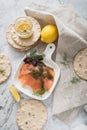 Gravlax a raw, marinated graved salmon with dill on plate with crispbread, Scandinavian mustard sauce, lemon and linen towel on Royalty Free Stock Photo