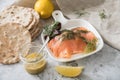 Gravlax a raw, marinated graved salmon with dill on plate with crispbread, Scandinavian mustard sauce, lemon and linen towel on Royalty Free Stock Photo