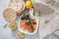 Gravlax a raw, marinated graved salmon with dill on plate with crispbread, Scandinavian mustard sauce, lemon and linen towel on Royalty Free Stock Photo