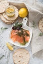 Gravlax a raw, marinated graved salmon with dill on plate with crispbread, Scandinavian mustard sauce, lemon and linen towel on Royalty Free Stock Photo