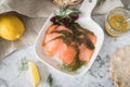 Gravlax a raw, marinated graved salmon with dill on plate with crispbread, Scandinavian mustard sauce, lemon and linen towel on Royalty Free Stock Photo