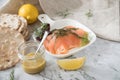 Gravlax a raw, marinated graved salmon with dill on plate with crispbread, Scandinavian mustard sauce, lemon and linen towel on Royalty Free Stock Photo