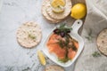 Gravlax a raw, marinated graved salmon with dill on plate with crispbread, Scandinavian mustard sauce, lemon and linen towel on Royalty Free Stock Photo