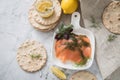 Gravlax a raw, marinated graved salmon with dill on plate with crispbread, Scandinavian mustard sauce, lemon and linen towel on Royalty Free Stock Photo