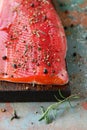 Gravlax, scandinavian beet cured spiced salmon on the board, top view, salted red fish