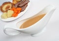 Gravy boat with dinner Royalty Free Stock Photo