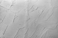 Gray abstract texture of surface covered with putty. Wood background covered with putty.