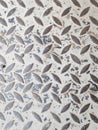 Gray anti slip embossed metal steel plate with diagonal diamond pattern texture. Royalty Free Stock Photo