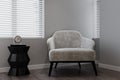 Gray armchair setting by the window. 3D rendering