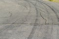 Gray asphalt with black tire tracks. An old country road with cr Royalty Free Stock Photo