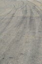 Gray asphalt with black tire tracks. An old country road with cr Royalty Free Stock Photo