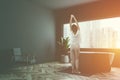 Gray bathroom corner tub and armchair, woman Royalty Free Stock Photo