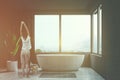 Gray bathroom interior, tub and window, woman Royalty Free Stock Photo