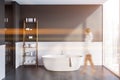 Gray bathroom with tub and shelves, woman