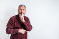 Gray bearded man have the finger on lips as man gesturing shh sign, please be silent concept Royalty Free Stock Photo