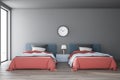 Gray bedroom interior with two beds and clock Royalty Free Stock Photo