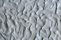Gray bentonite facial clay mask, face cream, body wrap texture close up, selective focus. Abstract background with brush strokes Royalty Free Stock Photo