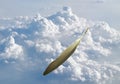Gray bird feather floating on cloud in bright sky background Royalty Free Stock Photo