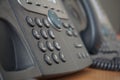 Gray and black business wired phone with receiver, dial and large display in the business office environment Royalty Free Stock Photo