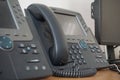 Gray and black business wired phone with receiver, dial and large display in the business office environment Royalty Free Stock Photo
