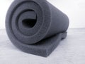 Gray or black sponge foam roll in a room