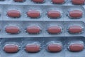 Gray blister texture with lots of brown pills in pack