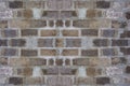 Gray block wall background. Grey textured building exterior surface with rough stacked big bricks. Tiled structure of stonewall