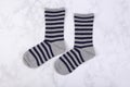 Gray blue navy stripes socks on white marble background Royalty Free Stock Photo