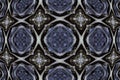 Gray blue symmetrical pattern of curved shapes on a black background.