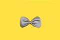 A gray bow tie on a yellow background Royalty Free Stock Photo