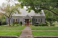 Gray Brick Cape Cod House on Overcast Day