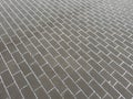 A gray brick sidewalk with snow on it Royalty Free Stock Photo