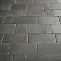 gray brick wall a black slate tile floor with a white background tile Royalty Free Stock Photo