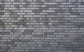 Gray brick wall, gloomy background, black brick wall of dark stone texture, black wallpaper Royalty Free Stock Photo