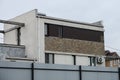 Gray brown facade of a modern private house with small windows Royalty Free Stock Photo