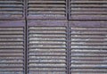 Gray brown metal rusty jalousie lattice close-up. rough surface texture Royalty Free Stock Photo