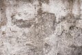 Gray and brown shabby concrete wall with flaky plaster. Torn rough old cement wall texture, background. Vintage, natural cracked d Royalty Free Stock Photo