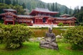 Gray Buddha statue in front of buddhist temple Royalty Free Stock Photo