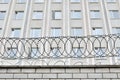 Gray building is fenced with barbed wire. Symbol of dictatorial and authoritarian regime. Royalty Free Stock Photo