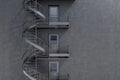 Gray building with spiral fire escape stairs Royalty Free Stock Photo