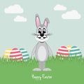 Gray bunny on green field colorful eggs