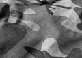 Gray Camouflage textile uniform close-up with blur effect.