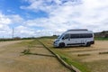 Gray camper van parked in an empty parking lot