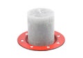 Gray candle on red drip plate