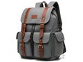 Gray canvas backpack with brown leather trim isolated on white background Royalty Free Stock Photo