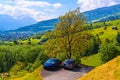 Gray car and brocken car on the road near wooden cottage houses on green fields, Grabs, Werdenberg, St. Gallen Switzerland Royalty Free Stock Photo