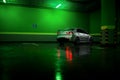 Gray car stay at underground parking lot and reflect in wet asphalt Royalty Free Stock Photo