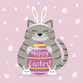 A gray cat in the ears and slippers of a rabbit sits and holds a purple Easter egg. Happy easter.