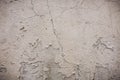 Gray cement wall with traces of the brush on the crumbling plaster. textural composition